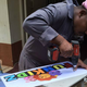 A FunKidz staffer making a sign for the store.